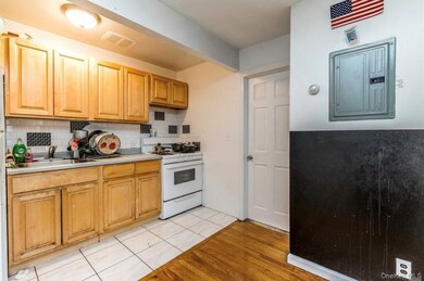 Kitchen with white gas range, light countertops, tasteful backsplash, and light tile patterned floors