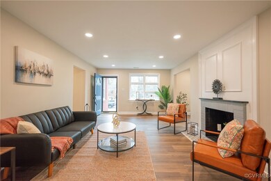 Living area with a brick fireplace, recessed light