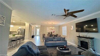 Living area with crown molding, light tile pattern