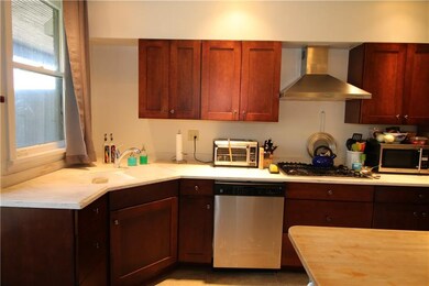 Kitchen with corian counters, stainless dishwasher