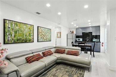 Living area with recessed lighting and light wood-style finished floors