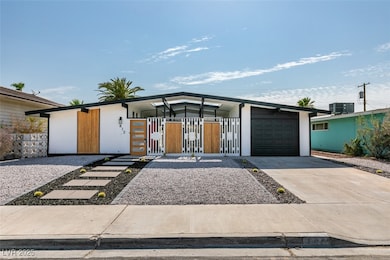 Mid-century inspired home featuring concrete drive