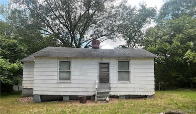 Rear view of property featuring entry steps and a