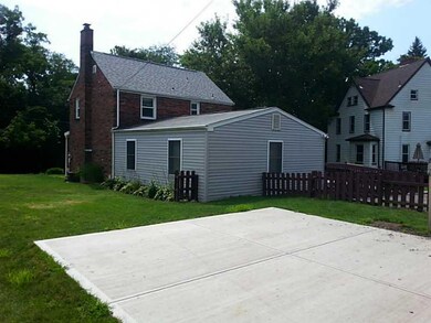 Exterior Back. **CEMENT PAD WAS BUILT FOR A BASKET