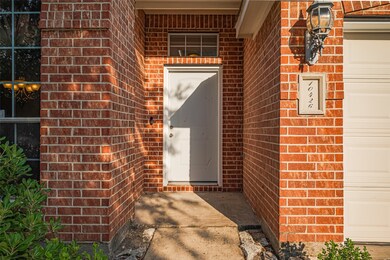 Tucked beneath a recessed brick entryway, the fron