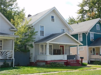 View of left of home with a porch and a front lawn
