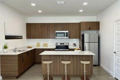 Kitchen with a sink, a breakfast bar area, a center island, stainless steel appliances, and visible vents