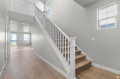 Stairs featuring hardwood / wood-style flooring and baseboards