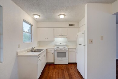 Kitchen with white appliances, under cabinet rang