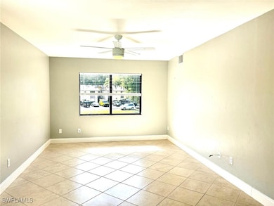 Spare room with visible vents, a ceiling fan, base