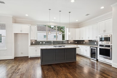 Chef's kitchen features SS appliances, an island w