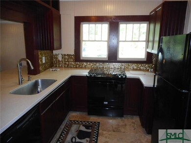 Kitchen with corian counter tops, farm sink and tr