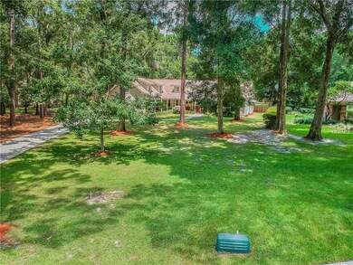 Your new private oasis sits on nearly an acre and is not in a flood zone!