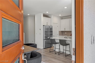 Kitchen with high quality fridge, light countertop