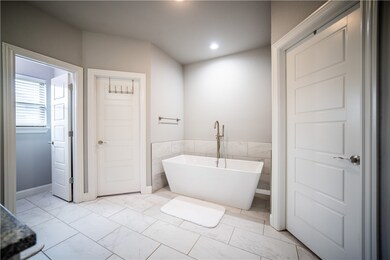 Primary bath offers a soaker tub, walk in shower,