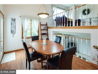 The bright dining boasts a high ceiling and door t