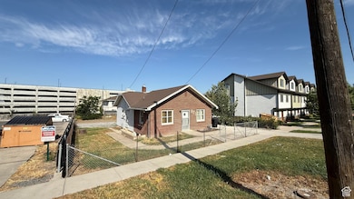 View of property exterior featuring a fenced front yard and brick siding