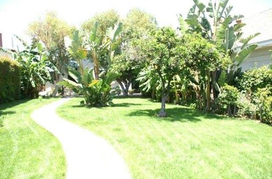 VIEW OF FRONT YARD INSIDE GATED ENTRY. HOUSE IS ON
