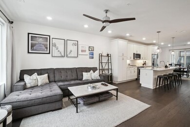 Living room featuring dark wood-style flooring, ceiling fan, and recessed lighting