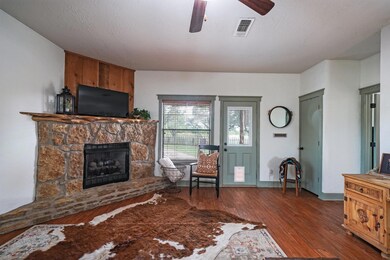 Living room with ceiling fan, dark hardwood / wood