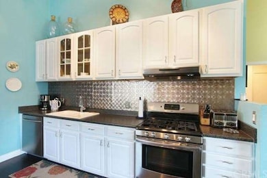 Updated kitchen features a tin backsplash.