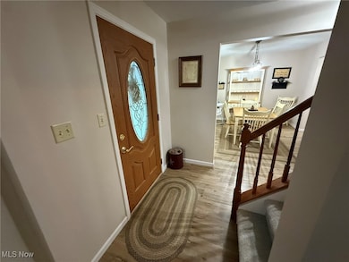 Entrance foyer featuring light wood-type flooring and stairs