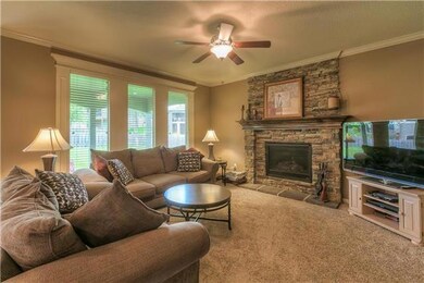 family room with stone stacked fireplace