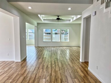 Living area with tray style ceiling, creates an in