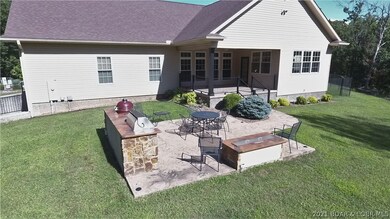 Stamped concrete grill area with fire pit.