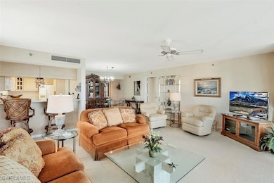 Carpeted living room featuring ceiling fan with no