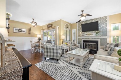 The living area features a fireplace with glass ti