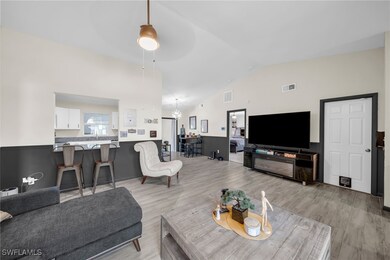 Living area with a ceiling fan, light wood finishe