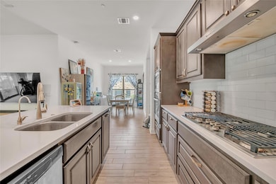 Kitchen featuring appliances with stainless steel