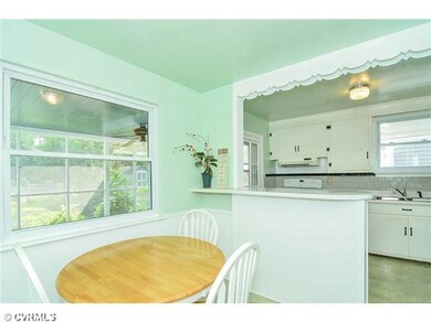 Breakfast Nook - Eat-in kitchen with breakfast bar overlooks screened porch.