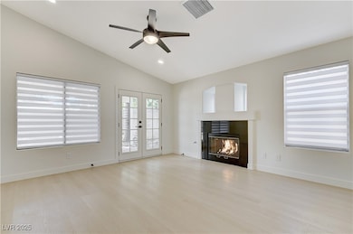 Unfurnished living room featuring ceiling fan, a t