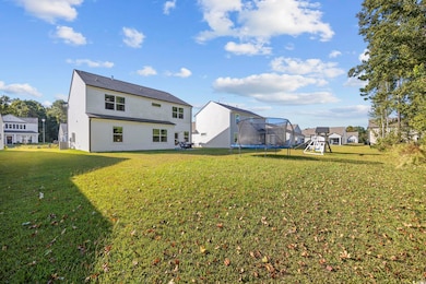 Rear view of property with a yard, a playground, a