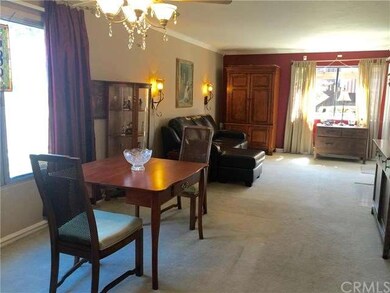 Light filled dining area has lighted ceiling fan.