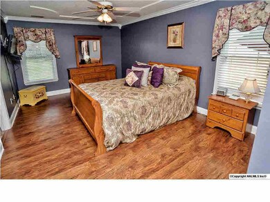 Retreat to the master bedroom with crown moulding, beautiful floors and attached bath.