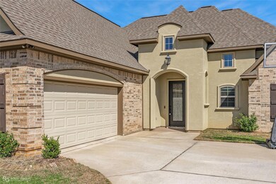 French country home featuring stucco siding, concr