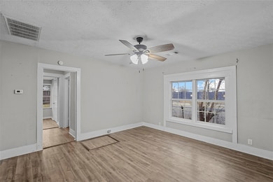 Unfurnished room featuring ceiling fan, baseboards
