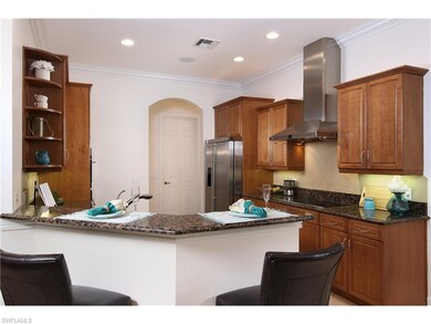 Kitchen and breakfast bar. Door to laundry room an