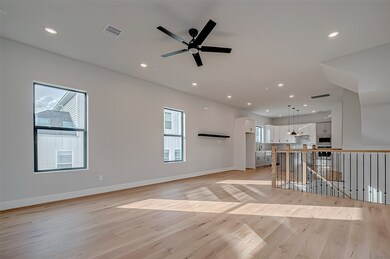 A spacious, open-concept living area with hardwood