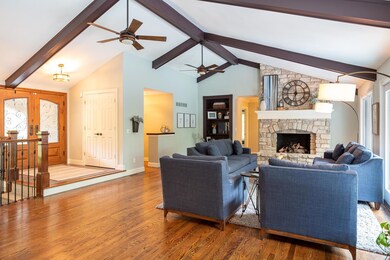 Great Room with beamed ceiling and Stone Fireplace