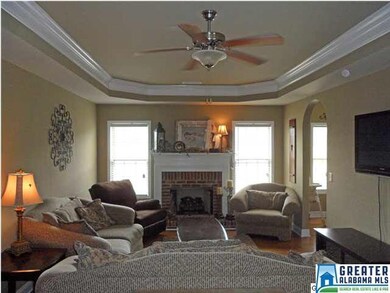 Gorgeous living room with a tray ceiling and crown