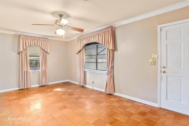 Spare room featuring crown molding and ceiling fan
