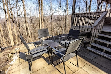 View of patio / terrace with stairs and a deck