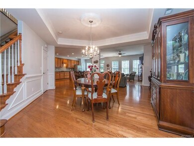 Open concept living with detailed trim, tray ceili