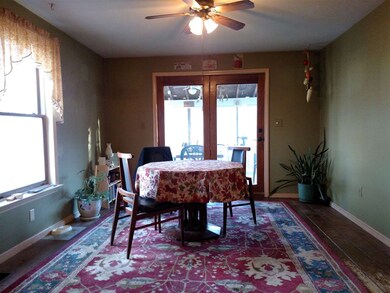 Open eating area faces a screen porch.