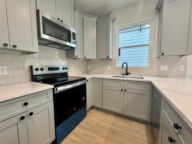 Kitchen featuring a sink, light wood-style floori