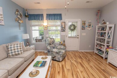 Living area with light wood finished floors and baseboards